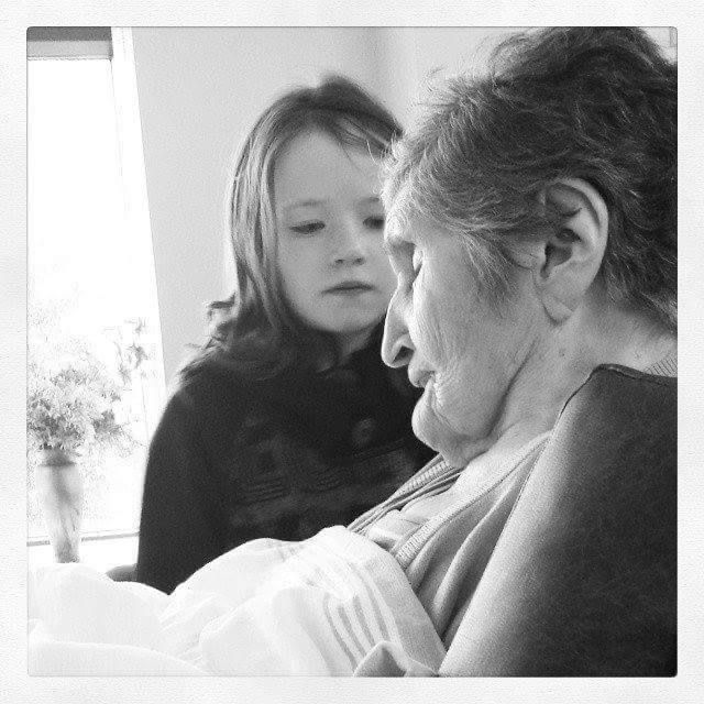 Child and elderly woman sharing a moment.